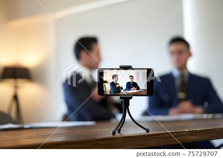 Business talk A businessman shooting a video 75729707