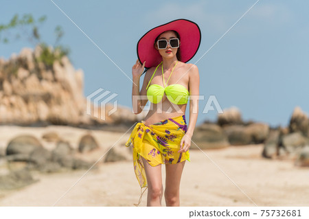 Portrait of woman posing outdoors at the sea beach Portrait of woman posing outdoors at the sea beach 75732681