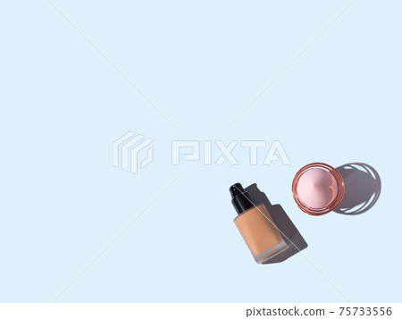 Make up foundation bottle and application egg brush on blue Make up foundation bottle and application egg brush on blue 75733556