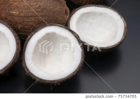 cut fresh coconut on a dark background. vitamin fruits. healthy food 75734705
