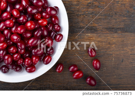 Dogwood berries in a white plate 75736873