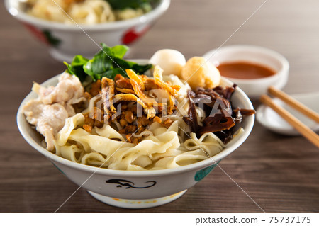 Malaysia hawker food - Pan Mee is made with a simple flour-based dough with anchovy broth Malaysia hawker food - Pan Mee is made with a simple flour-based dough with anchovy broth 75737175