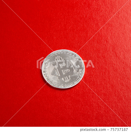 A close up on bitcoin on red background A close up on bitcoin on red background 75737187