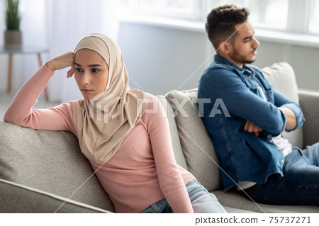 Frustrated man and woman sitting apart after fight Frustrated man and woman sitting apart after fight 75737271