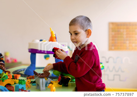 The preschool boy immersed in a game with a constructor 75737897