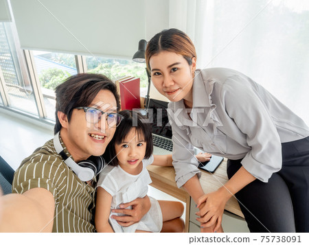 happy family in bed room concept. Enjoying being together. Lying in bed and making selfie. happy family in bed room concept. Enjoying being together. Lying in bed and making selfie. 75738091