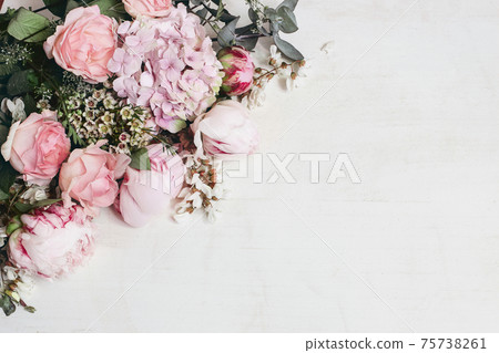 Spring, summer floral still life. Closeup of pink roses, hydrangeand peonies flowers. Bouquet of Eucalyptus isolated on white wooden background. Decorative corner, web banner. Flat lay, top view. 75738261
