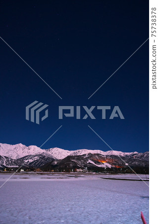 View of Shirouma Sanzan from Hakuba Village on a moonlit night in winter View of Shirouma Sanzan from Hakuba Village on a moonlit night in winter 75738378