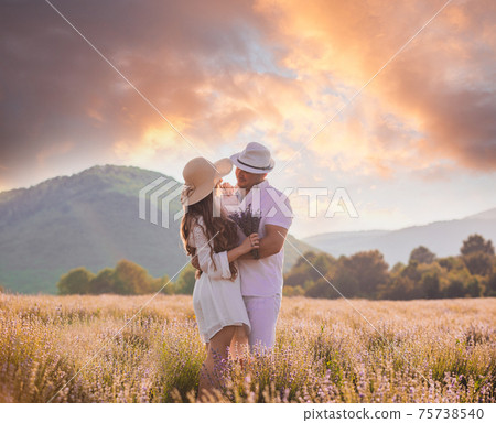Lovely young couple embracing at the lavender field Lovely young couple embracing at the lavender field 75738540