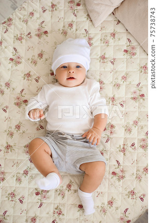 Portrait of a crawling baby on the bed in her room. 75738743