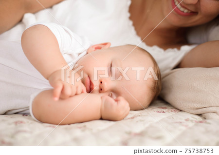Sweet baby boy sleeping in bed with his mother 75738753