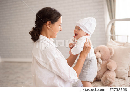 Mother, playing with her toddler boy smiling 75738768