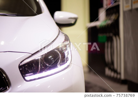 The driver pump the car's gasoline with fuel at the petrol station. Car refueling at a gas station. 75738769