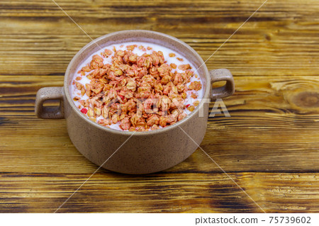 Granola with milk in bowl on wooden table. Healthy breakfast concept 75739602