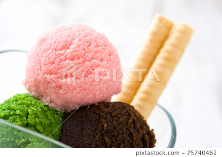 Ice cream scoops in crystal bowl Ice cream scoops in crystal bowl 75740461