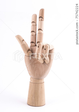 the gesture of the number three made with a jointed wooden hand 75742224