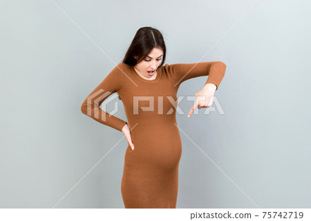 Young surprise or shocked woman pregnant isolated colored background. expression female 75742719