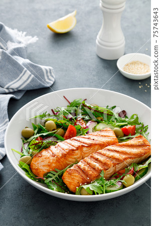 Grilled salmon fillet and fresh vegetable salad. Mediterranean diet. Grilled salmon fillet and fresh vegetable salad. Mediterranean diet. 75743643