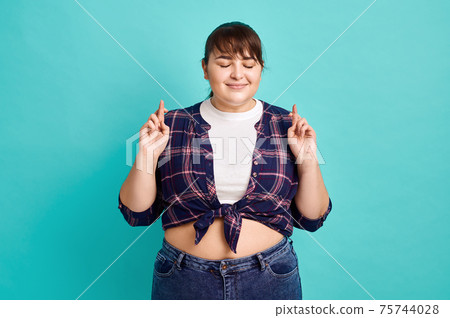 Pretty overweight woman makes wish, body positive Pretty overweight woman makes wish, body positive 75744028