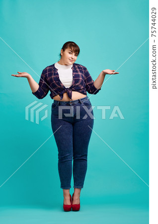 Cute overweight woman in studio, body positive 75744029