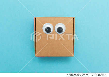 Craft box with eyes. Box for moving. Square Emoji made of paper. Funny paper cubes with eyes. Craft box with eyes. Box for moving. Square Emoji made of paper. Funny paper cubes with eyes. 75746985