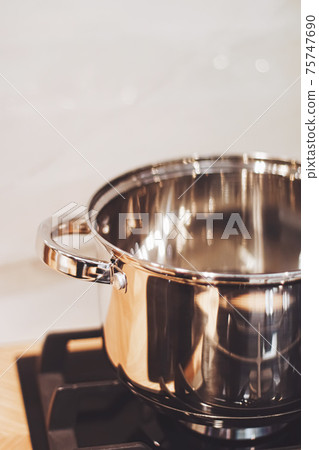 Aluminium pot on a kitchen stove, cookware and cooking Aluminium pot on a kitchen stove, cookware and cooking 75747690