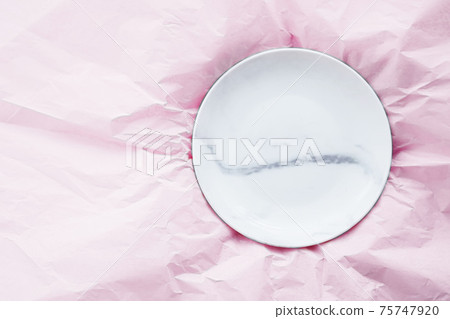 Marble plate inside pink paper packaging as flatlay background, food service flat lay and meal delivery 75747920