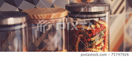 Pasta in dry food storage containers in the kitchen, pantry organisation and home decor Pasta in dry food storage containers in the kitchen, pantry organisation and home decor 75747926