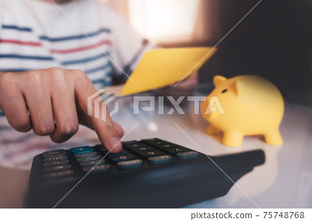 Business hands holding saving account passbook with calculator, account and saving 75748768