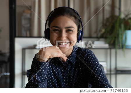 Headshot of smiling Indian woman talk on video call Headshot of smiling Indian woman talk on video call 75749133