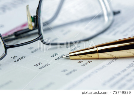 Newspaper, pen and glasses Newspaper, pen and glasses 75749889