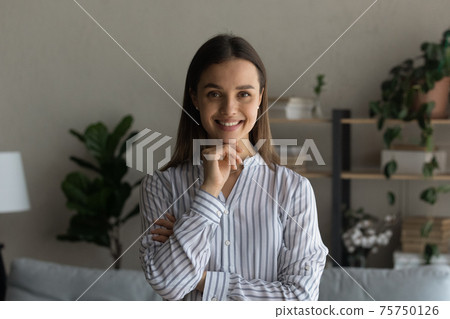 Head shot portrait smiling attractive woman looking at camera Head shot portrait smiling attractive woman looking at camera 75750126