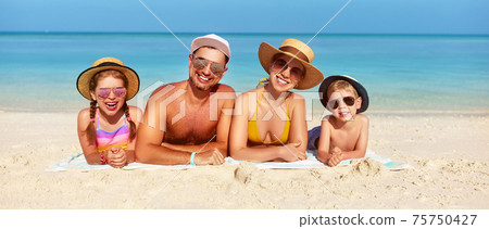 Loving family spending day on beach 75750427