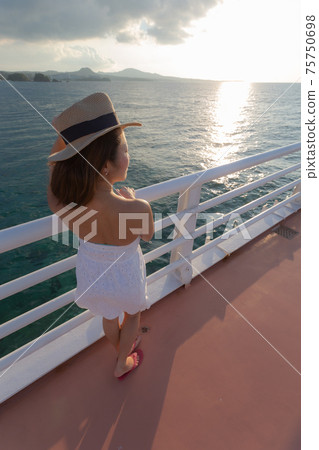 A girl who came for a walk to a bridge on the sea A girl who came for a walk to a bridge on the sea 75750698
