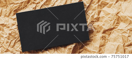 Black business card flatlay on brown parchment paper background, luxury branding flat lay and brand identity design for mockup 75751017