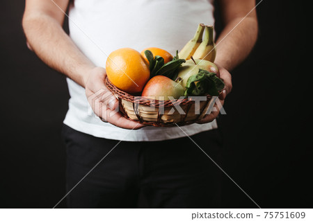 Healthy vegetarian food. Fat man with fresh fruits 75751609