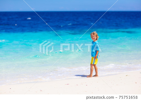 Kids playing on beach. Children play at sea. Kids playing on beach. Children play at sea. 75751658
