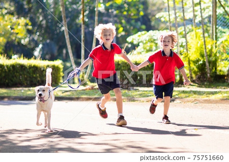 Child walking dog. Kids and puppy. Boy and pet. Child walking dog. Kids and puppy. Boy and pet. 75751660