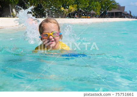 Kids playing on beach. Children play at sea. 75751661