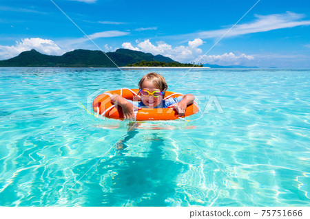 Child on tropical beach. Sea vacation with kids. Child on tropical beach. Sea vacation with kids. 75751666