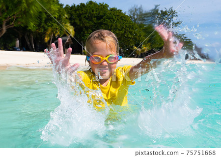 Kids playing on beach. Children play at sea. Kids playing on beach. Children play at sea. 75751668