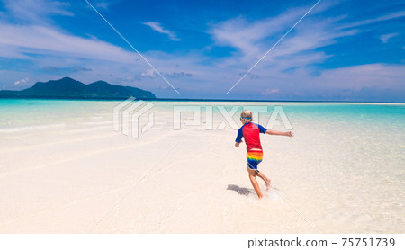 Kids playing on beach. Children play at sea. Kids playing on beach. Children play at sea. 75751739