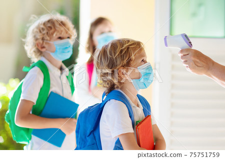 Temperature check at school. Child in mask. Temperature check at school. Child in mask. 75751759