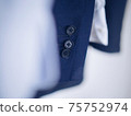 Suit hung on a hanger 75752974