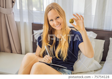 NFT Young woman, a digital artist, creates digital art on a tablet at home and shows a coin with the inscription NTF - non fungible token. Remote work, digital nomad, digital painting, animation NFT Young woman, a digital artist, creates digital art on a tablet at home and shows a coin with the inscription NTF - non fungible token. Remote work, digital nomad, digital painting, animation 75754128