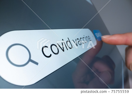 Close-up view of searching information on COVID 19 vaccine on the internet Close-up view of searching information on COVID 19 vaccine on the internet 75755559