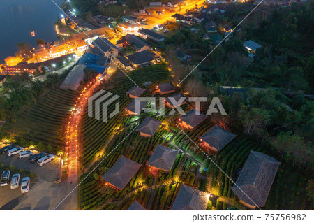 Aerial view of Ban Rak Thai village, chinese hotel resort at night, Mae Hong Son, Thailand. Nature landscape in travel trip and vacation. Aerial view of Ban Rak Thai village, chinese hotel resort at night, Mae Hong Son, Thailand. Nature landscape in travel trip and vacation. 75756982