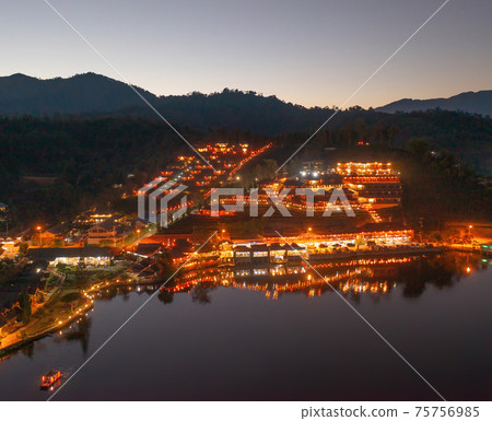 Aerial view of Ban Rak Thai village, chinese hotel resort at night, Mae Hong Son, Thailand. Nature landscape in travel trip and vacation. Aerial view of Ban Rak Thai village, chinese hotel resort at night, Mae Hong Son, Thailand. Nature landscape in travel trip and vacation. 75756985