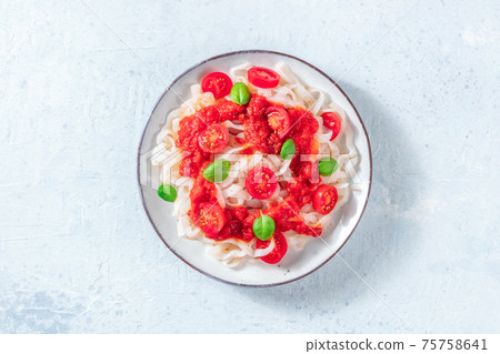 Konjac pasta with tomatoes, a healthy vegan dish 75758641