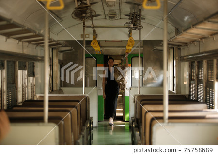 LGBT Transgender model travels on train at station railway 75758689